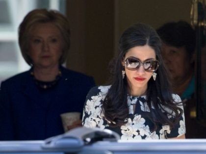 As her closest aide Huma Abedin, center, precedes her, Democratic presidential candidate Hillary Clinton, left, emerges from her residence following a private meeting with Sen. Elizabeth Warren, D-Mass., the day after Warren’s endorsement, Friday, June 10, 2016, in Washington. (AP Photo/J. Scott Applewhite)
