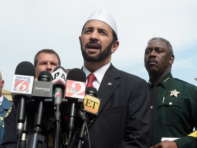 Imam Muhammad Musri, center, president of the Islamic Society of Central Florida, addresses reporters while flanked by members of law enforcement and community leaders during a news conference after a shooting involving multiple fatalities at a nightclub in Orlando, Fla., Sunday, June 12, 2016. (AP Photo/Phelan M. Ebenhack)