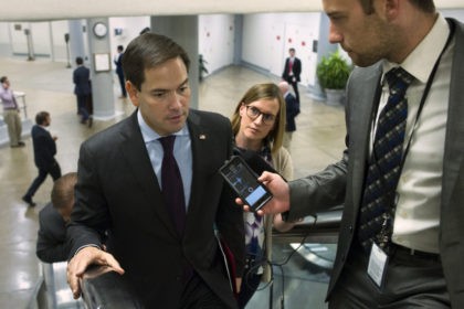 Sen. Marco Rubio of Fla. speaks with reporters while he walks through the Capitol in Washi