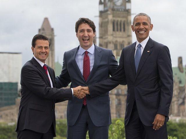 President Barack Obama, Canadian Prime Minister Justin Trudeau and Mexican President Enrique Pena Neito stand in front of Parliament Hill for a group photo during the North America Leaders' Summit at the National Gallery of Canada, Wednesday, June 29, 2016 in Ottawa, Canada. (AP Photo/Pablo Martinez Monsivais)