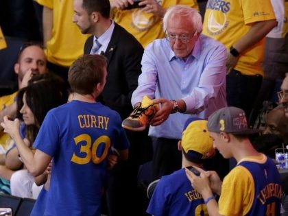 Democratic presidential candidate Sen. Bernie Sanders, I-Vt., hands a shoe to a fan during