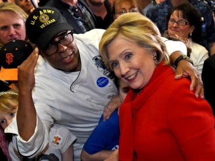 U.S. Army veteran Basil Kimbrew poses with Democratic presidential candidate Hillary Clinton after she spoke at a get-out-the-caucus event at the Mountain Shadows Community Center on February 14, 2016 in Las Vegas, Nevada. Clinton is challenging Sen. Bernie Sanders for the Democratic presidential nomination ahead of Nevada's February 20th Democratic …