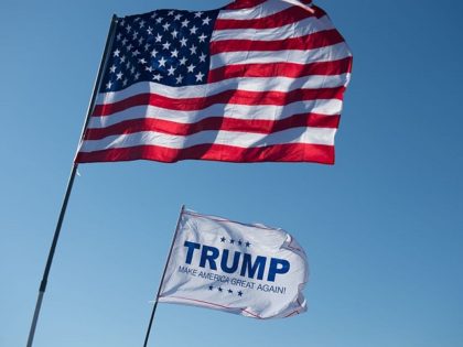 An American Flag and a Donald Trump flag wave outside a Donald Trump rally at Millington R