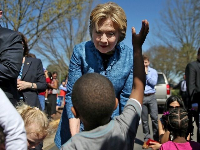 Democratic presidential candidate Hillary Clinton greets children outside of a polling sta