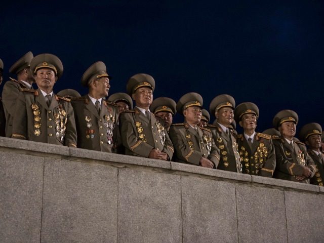 Military officers attend a torchlight parade on Kim Il-Sung square during festivities mark
