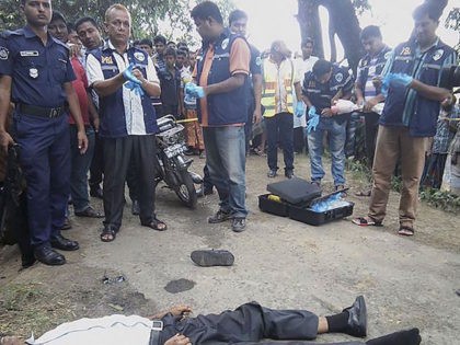 EDITORS NOTE: Graphic content / Bangladeshi investigators look over the body of 58-year-ol