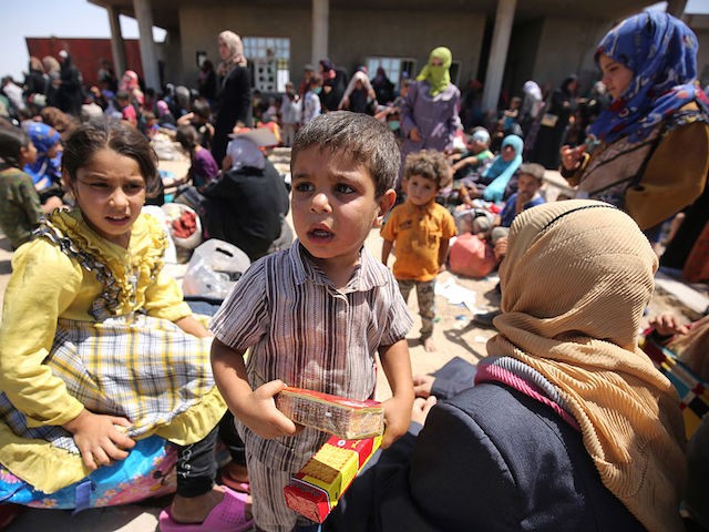 Iraqis who fled the violence in their village of Saqlawiyah, north west of Fallujah, wait