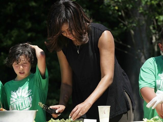 Michelle Obama prepares ingredients from a White House Kitchen Garden harvest for cooking