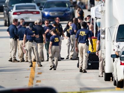 Members of the FBI gather near the Pulse nightclub June 13, 2016 in Orlando, Florida. Forty-nine people died and more than 50 were injured early June 12 when a heavily-armed gunman opened fire and seized hostages at a gay nightclub in Orlando, Florida, in the worst mass shooting in US …