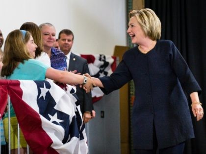 Democratic presidential candidate Hillary Clinton shakes hands with a young girl during a
