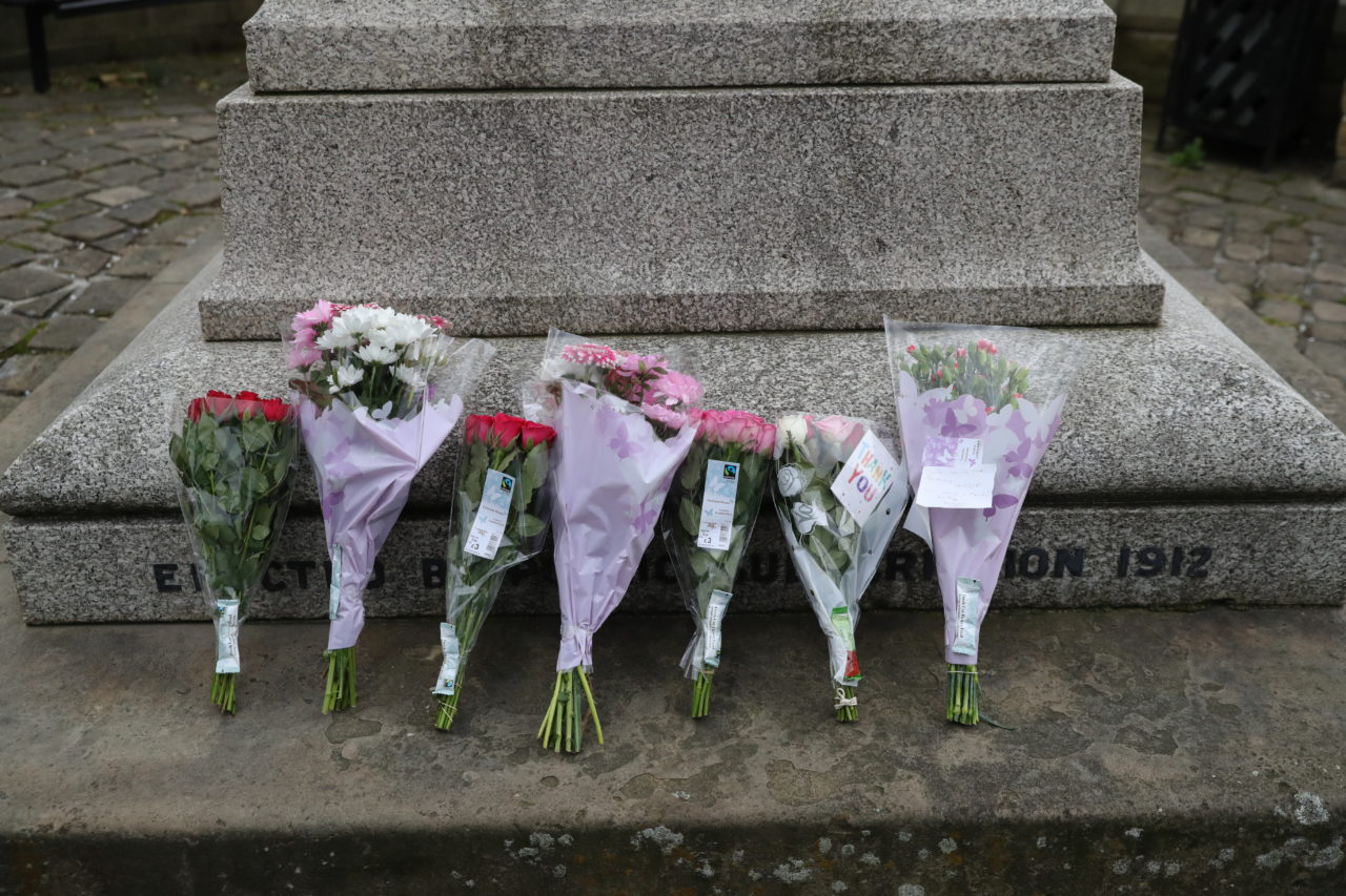 BIRSTALL, ENGLAND - JUNE 16: Floral tributes are placed in Market Square next to the statue of Joseph Priestley a local hero after the murder of Jo Cox, 41, Labour MP for Batley and Spen, who was shot and stabbed by an attacker at her constituicency on June 16, 2016 in Birstall, England. A man also suffered slight injuries during the attack. Jo Cox has died after being shot and repeatedly stabbed while holding her weekly surgery at Birstall Library, Birstall near Leeds. A 53-year old man has been arrested in connection with the crime. (Photo by Christopher Furlong/Getty Images)