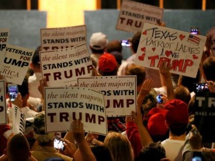 Supporters of Republican presidential candidate Donald Trump hold signs on June 16, 2016 at Gilley's in Dallas, Texas.