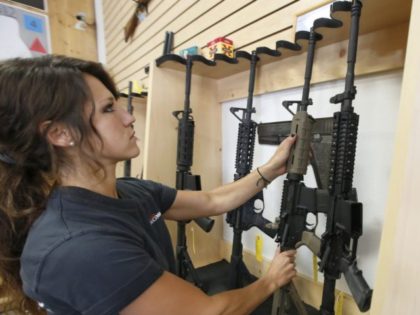 SPRINGVILLE, UT - JUNE 17: Courtney Manwaring puts away an AR-15 semi-automatic gun at Ac