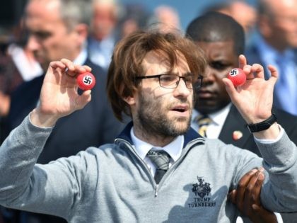 Comedian Lee Nelson is taken away by security while holding golf balls stamped with swastika as he protests against Presumptive Republican nominee for US president Donald Trump a he gave a press conference on the 9th tee at his Trump Turnberry Resort on June 24, 2016 in Ayr, Scotland. Mr …