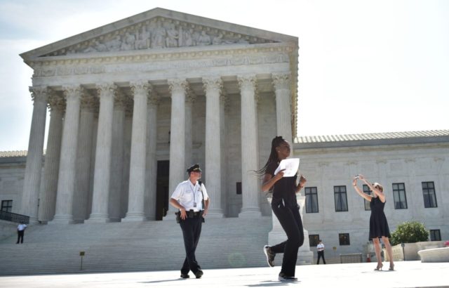 A reporter runs out of the US Supreme Court after the Court struck down a Texas law placin