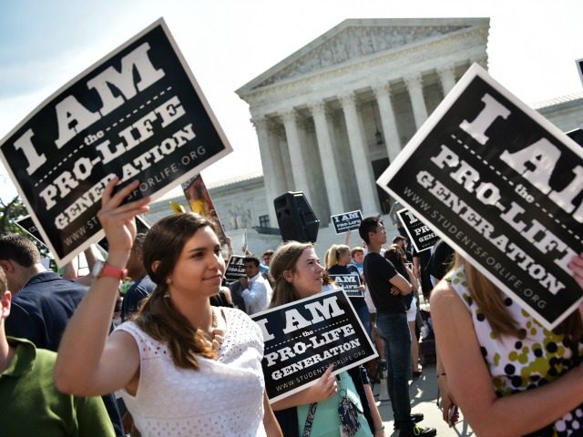 nti-abortion activists hold placards before a US Supreme Court ruling on a Texas law placing restrictions on abortion clinics, outside of the Supreme Court on June 27, 2016 in Washington, DC. In a case with far-reaching implications for millions of women across the United States, the court ruled 5-3 to …