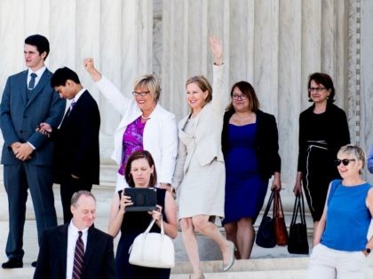 Texas abortion provider Amy Hagstrom-Miller and Nancy Northup, President of The Center for Reproductive Rights wave to supporters as they decend the steps of the United States Supreme Court on June 27, 2016 in Washington, DC.