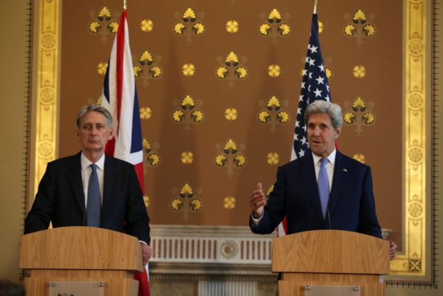 British Foreign Secretary Philip Hammond (L) and US Secretary of State John Kerry (R) hold