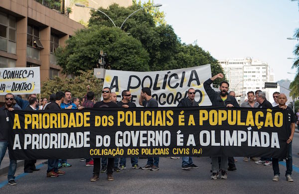 Civil police officers threatening to go on strike demonstrate against the government for arrears in their salary payments, in Rio de Janeiro, Brazil, June 27, 2016, t Earlier this month, Rio state authorities declared a "state of public calamity" over a major budget crisis in order to release emergency funds to finance the Olympic Games due to begin in August. / AFP / VANDERLEI ALMEIDA (Photo credit should read VANDERLEI ALMEIDA/AFP/Getty Images)