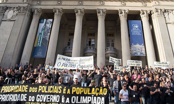 Civil police officers threatening to go on strike demonstrate against the government for arrears in their salary payments, in Rio de Janeiro, Brazil, June 27, 2016, t Earlier this month, Rio state authorities declared a "state of public calamity" over a major budget crisis in order to release emergency funds to finance the Olympic Games due to begin in August. / AFP / VANDERLEI ALMEIDA (Photo credit should read VANDERLEI ALMEIDA/AFP/Getty Images)