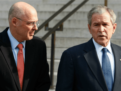 President George W. Bush (R) is joined by Treasury Secretary Henry Paulson while making a