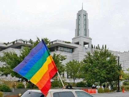 A car flies the gay pride flag in protest past the Mormon Conference center during the 179th Semi-Annual General Conference of the Mormon church on October 3, 2009 in Salt Lake City, Utah.