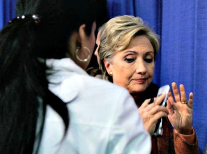 Hillary with a cell phone and Huma AP