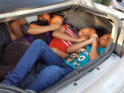 Human Smugglers pack people in trunk of car.