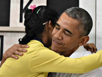 Obama hugs Malaysian girl AP