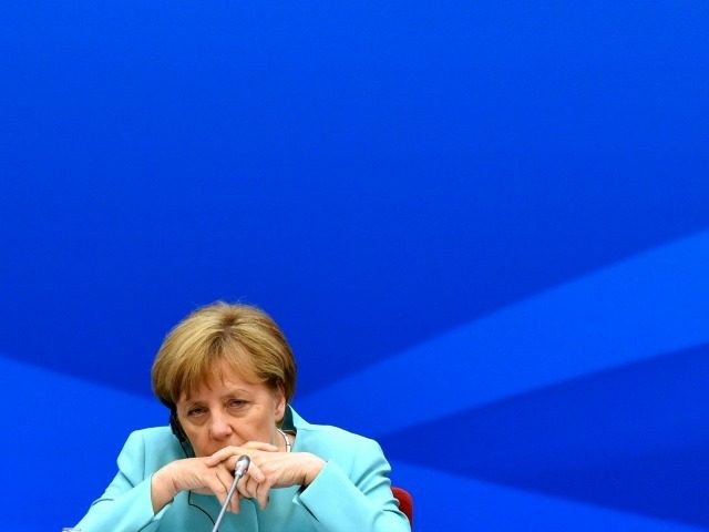 German Chancellor Angela Merkel listens as she attends Sino-German Economic Advisory with