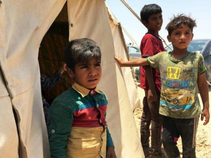 Iraq, Amriyat al-Fallujah : Displaced Iraqi boys stand on May 29, 2016 in front of a tent at a newly-opened camp in the government-held town of Amriyat al-Fallujah 50 kilometres (30 miles) southwest of Baghdad, which was set up to shelter people fleeing violence around the city of Fallujah. The …