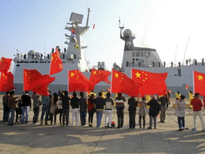 Chinese nationals living in Cyprus wave Chinese national flags as the Chinese frigate Yanc