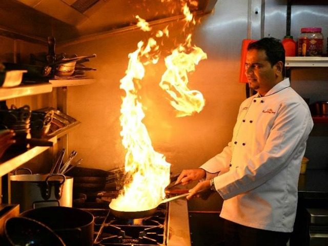 Oli Khan cooks in the Prince Of Bengal restaurant in Watford on June 1, 2016