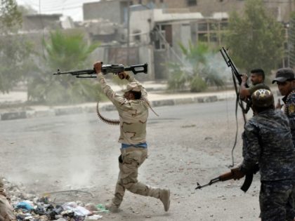 Iraqi government forces clash with Islamic State (IS) group fighters in Fallujah on June 18, 2016 as they hunt down holdout jihadists after retaking the city which was IS's last remaining major hub in Iraq.