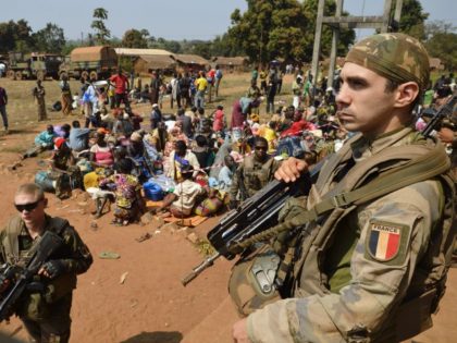 French soldiers taking part in 'Operation Sangaris' stand guard as Muslim people wait to seek refuge at the Boali church, on January 19, 2014, in Boali, some 100km north of Bangui.