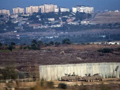 SDEROT, ISRAEL - JULY 18: Israeli tanks sit positioned next to a gap in the wall seperati