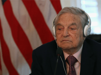 Billionaire George Soros litens to remarks by Commerce Secretary Penny Pritzker and Tunisian President Beji Caid Essebsi during a roundtable discussion with a group of American business leaders, at the Blair House May 20, 2015 in Washington, DC.