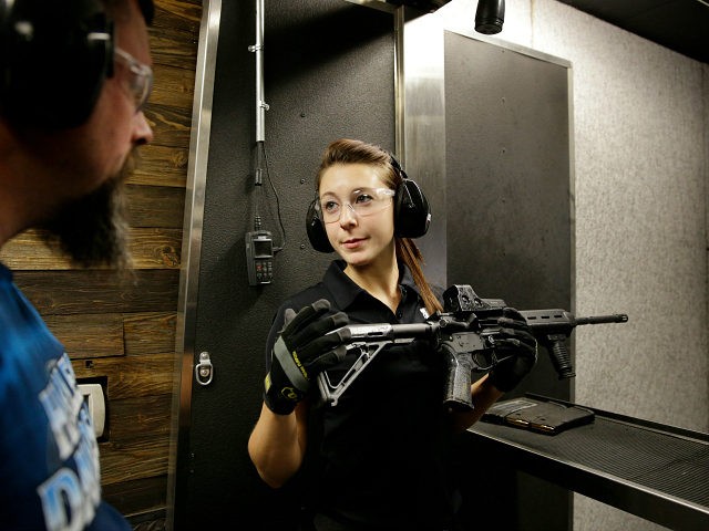 Shayna Zerbe instructs Garret Sloan, left, on how to fire a fully automatic machine gun at Machine Guns Vegas Thursday, Aug. 28, 2014, in Las Vegas. Most visitors to Machine Guns Vegas have already pulled the trigger on an Uzi or an M5, from the behind the controls of their …