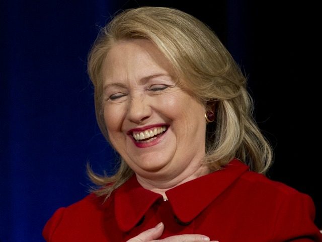 Former Secretary of State Hillary Clinton laughs as Secretary of Defense Leon Panetta joke
