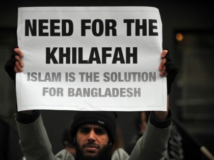 A Muslim protester holds a pro-Islamic rule sign during a protest outside the embassy of Bangladesh in central London on March 1, 2013, a day after the vice president of Jamaat-e-Islami party was found guilty of murder, religious persecution and rape by a war crimes tribunal in Bangladesh