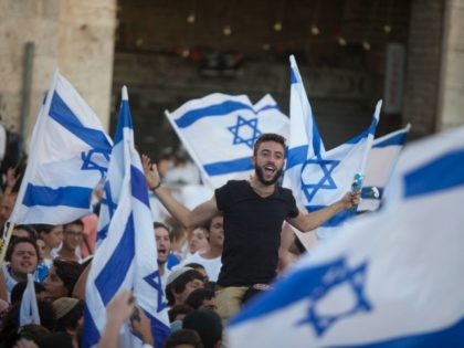Israelis dance with flags during a march marking Jerusalem Day on May 17, 2015 outside Jerusalem's old city, Israel. Israel is celebrating the anniversary of the 'unification' of Jerusalem, marking 48 years since it captured mainly Arab east Jerusalem during the 1967 Middle East war. (Photo by Lior Mizrahi/Getty Images)