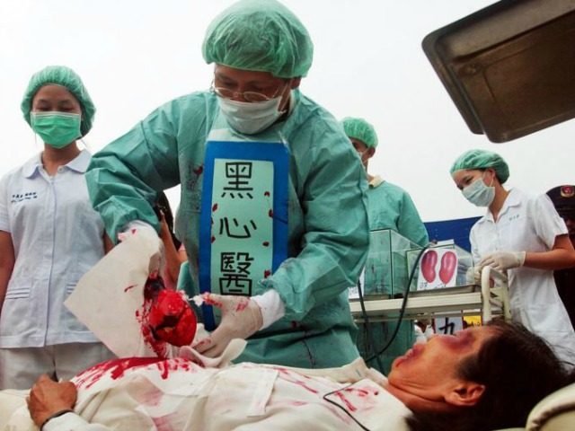 FILE – Falun Gong practitioners simulate organ harvesting in a mock Chinese labor camp in front of the Presidential Office in Taipei, Taiwan, April 23, 2006, in protest against China's suspected abuse and killing of Falun Gong members.