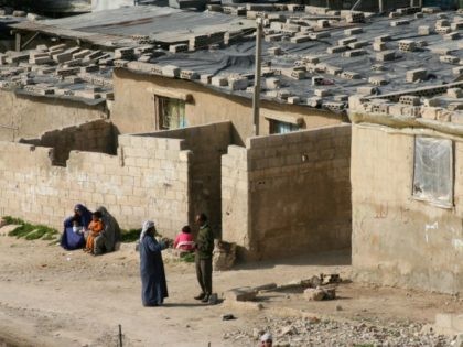 BAQAA, JORDAN- MARCH 28: Palestinian refugees chat beside their homes in Baqaa refugee cam