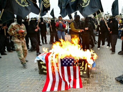 Members of the Islamic militant group Jihad burn U.S, Israeli and British flags over a mock coffin symbolic of Arab armies during an anti-American, British and Israeli rally April 11, 2003 at the Jabalia refugee camp, Gaza Strip.