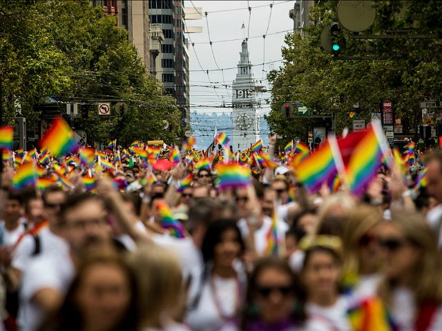 SAN FRANCISCO, CA- JUNE 28: San Francisco's Ferry Builiding is seen behind marchers in the