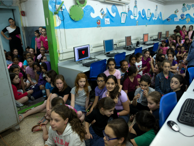 Israeli schoolchildren gather in a bomb shelter at a school in Jerusalem after sirens soun