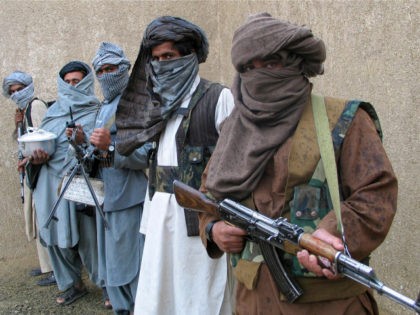 Taliban guerrilla fighters hold their weapons at a secret base in eastern Afghanistan in t