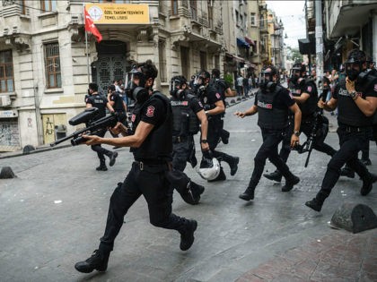 Turkish anti riot police officers fire rubber bullets to disperse demonstrators gathered f