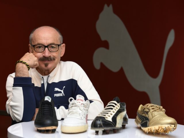 Helmut Fischer, former employee of Puma, poses with shoes of former international athletes