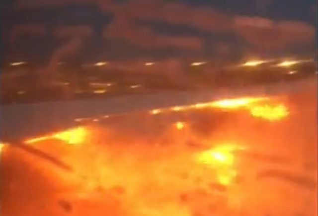The wing of a Singapore Airlines plane on fire on the tarmac of Singapore's Changi Airport